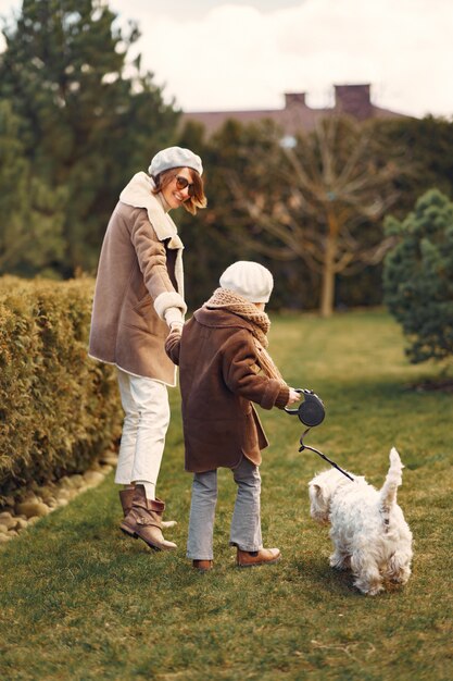 Mother with daughter walks with a dog