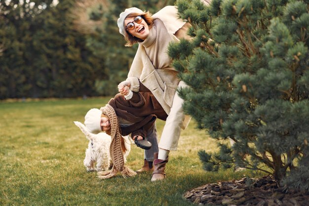 Mother with daughter walks with a dog