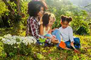 Free photo mother with daughters on the grass