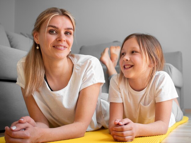 Free photo mother with girl exercise on mat