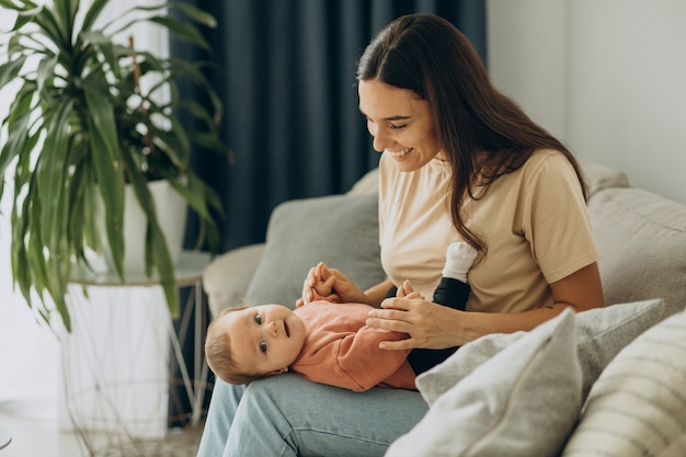 Mother with her baby girl at home