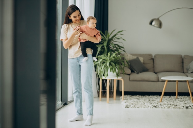 Mother with her baby girl at home