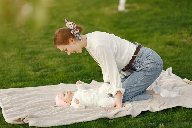 Mother with her baby spend time in a summer garden