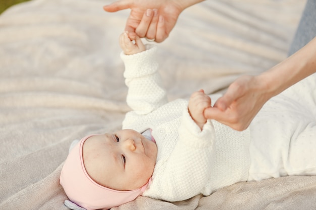 Mother with her baby spend time in a summer garden