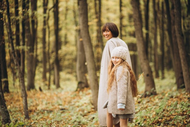 Mother with her daughter in park having fun