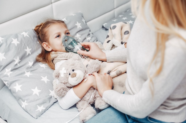 Mother with her illnes daughter in a bedroom