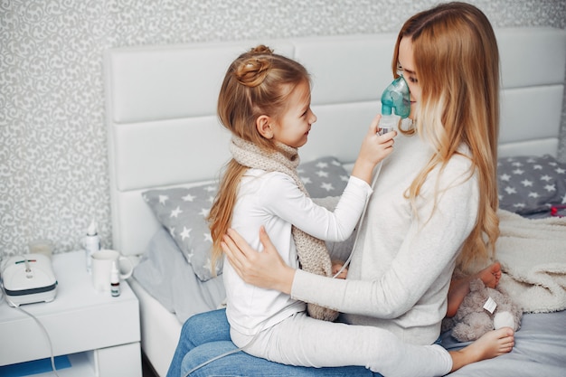 Mother with her illnes daughter in a bedroom