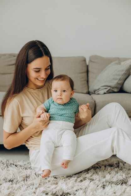 Mother with her little baby girl at home