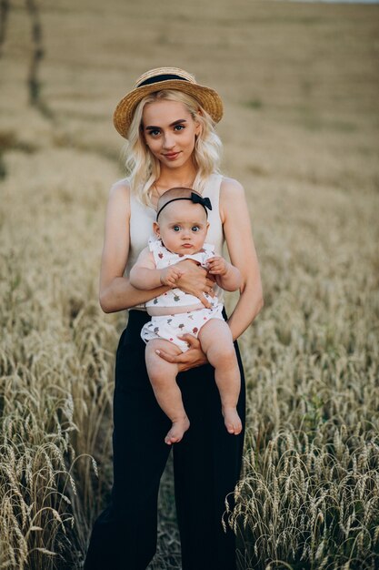 Mother with her little daughter in field