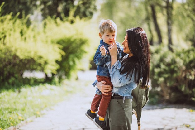 Mother with her little son having fun in park