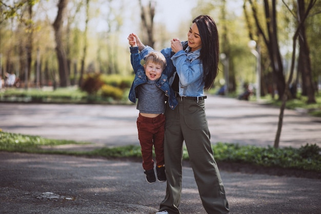 Mother with her little son having fun in park