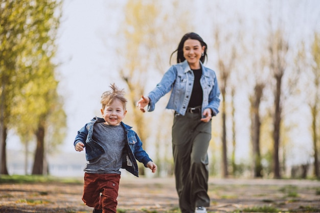 Mother with her little son having fun in park