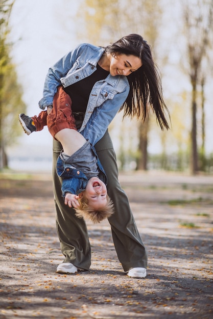 Mother with her little son having fun in park