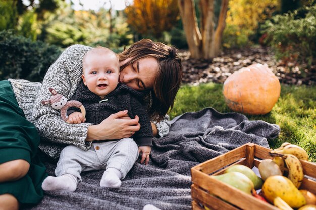 Mother with her little son having picnic on a back yard