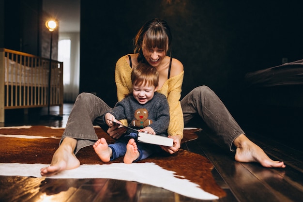 Mother with her son playing reading book