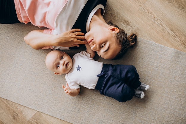 Mother with little baby boy practice yoga