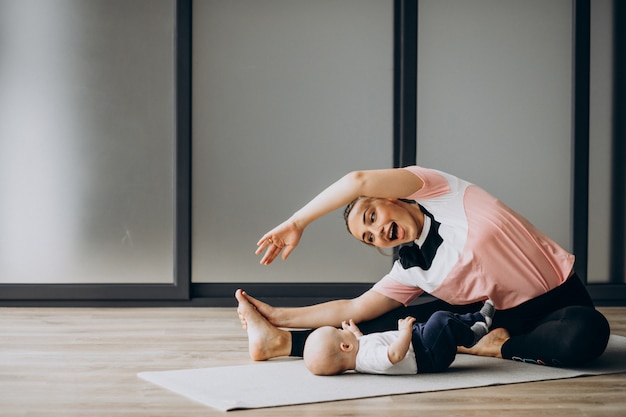 mother with little baby boy practice yoga