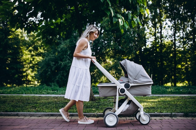 Mother with little baby daughter walking in park