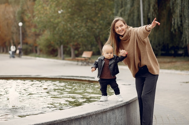 Mother with little child spend time in a park