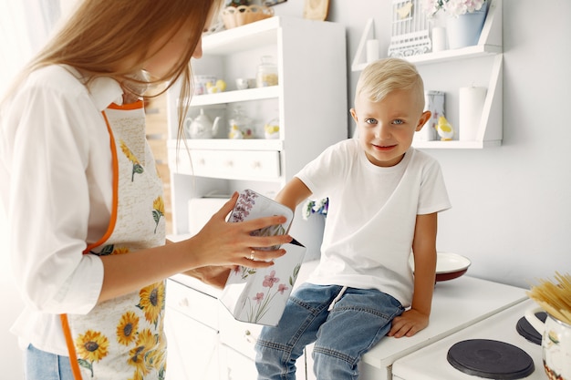 Mother with little children cooking at home