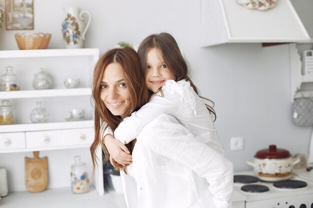 Mother with little children having fun at home