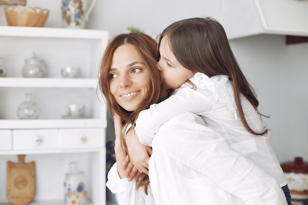 Mother with little children having fun at home