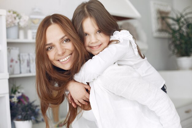 Mother with little children having fun at home