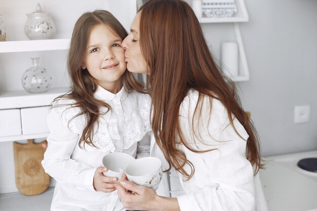 Mother with little children having fun at home