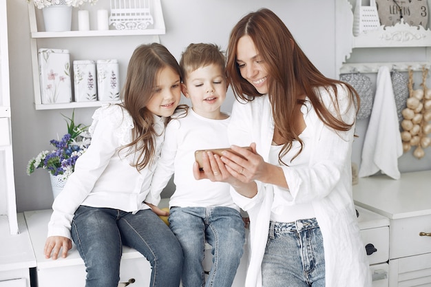 Mother with little children having fun at home