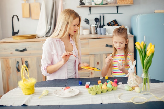 Mother with little daughter in a kitchen