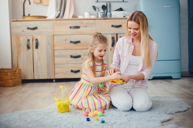 Mother with little daughter in a kitchen