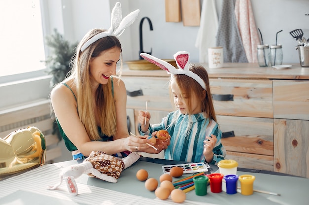 Mother with little daughter in a kitchen