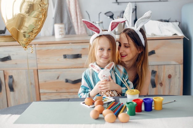 Mother with little daughter in a kitchen