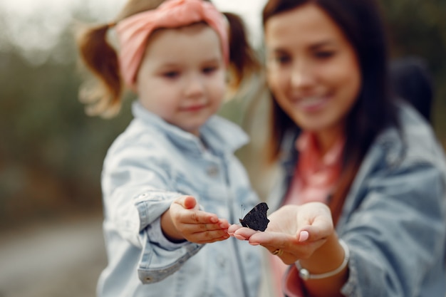 Mother with little daughter playing in a field