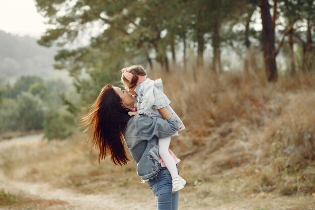 Mother with little daughter playing in a field