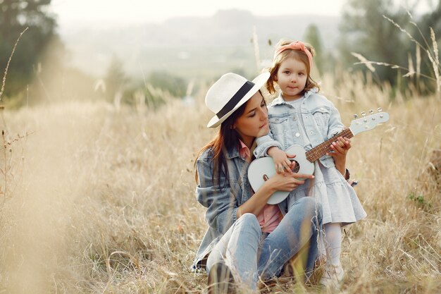 Mother with little daughter playing in a field