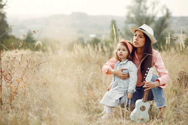 Mother with little daughter playing in a field