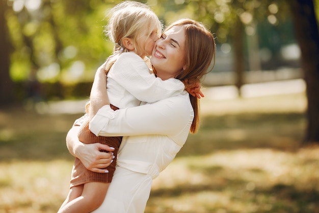 Mother with little daughter playing in a summer park