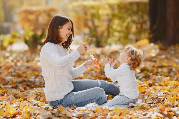 Mother with little daughter playing with a bubbles