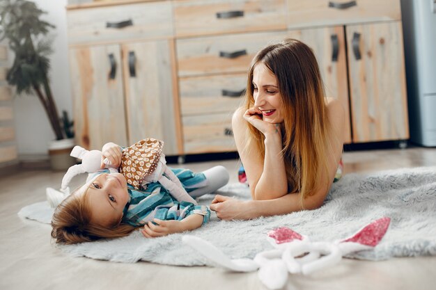 Mother with little daughter in a room