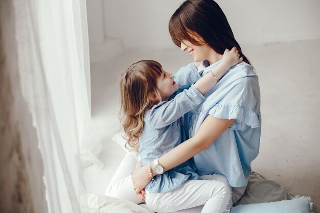 Mother with little daughter in a room