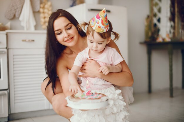 Mother with little daughter in a room