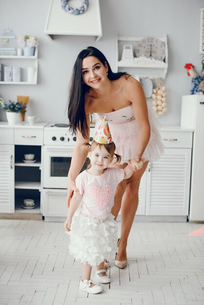 Mother with little daughter in a room