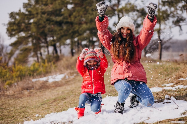 Free photo mother with little daughter in a winter forest