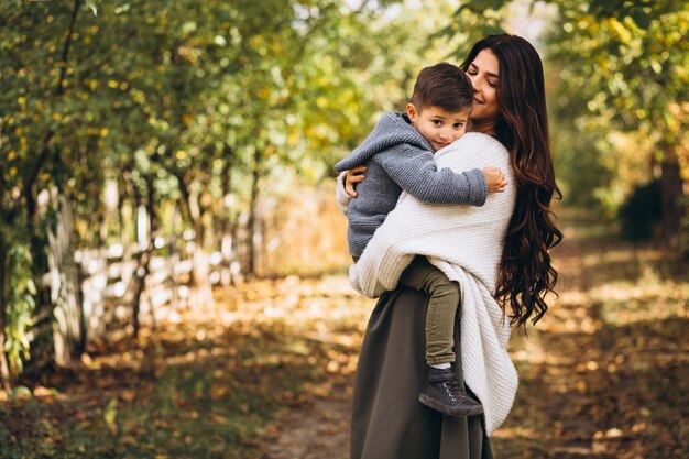 Mother with little son in an autumn park