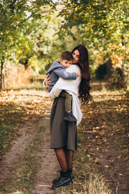 Mother with little son in an autumn park