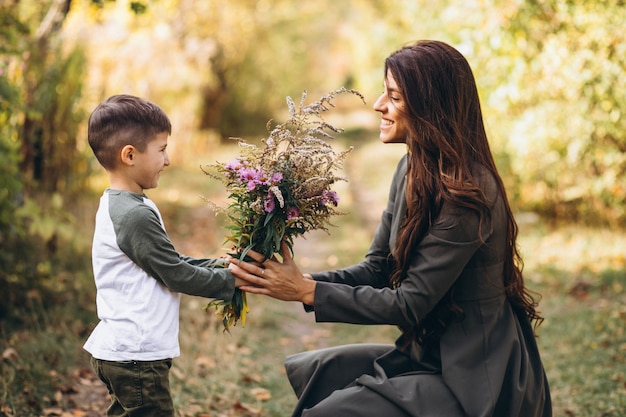 Mother with little son in an autumn park