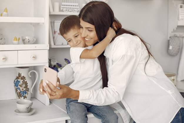 Mother with little son having fun at home