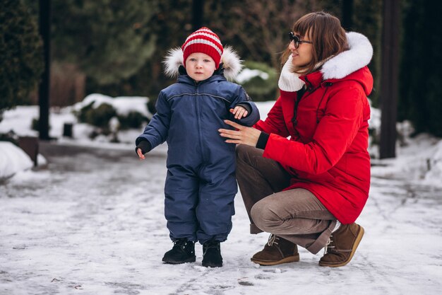 Mother with little son outside in winter