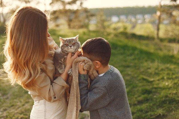 Mother with little son playing in a summer field